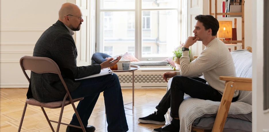 Therapist Having A Warm Conversation With An Adult Patient